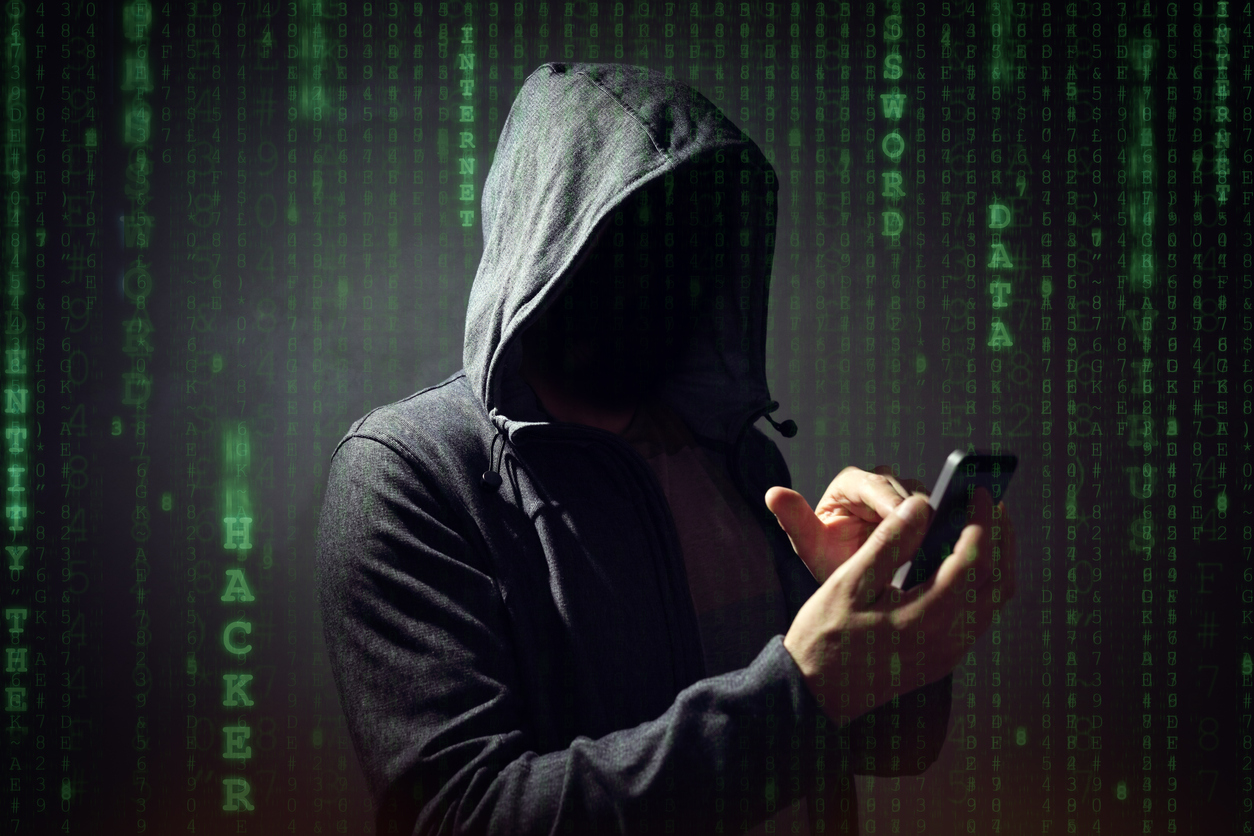 Computer hacker with mobile phone smartphone stealing data