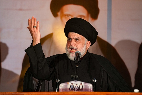 Iraqi Shiite cleric Muqtada al-Sadr delivers a speech before ending it abruptly due to his disapproval at the behaviour of an overenthusiastic crowd, in the central Iraqi city of Najaf on June 3, 2022 during a ceremony marking the death anniversary of his father Grand Ayatollah Mohammed Sadeq al-Sadr. (Photo by Qassem al-KAABI / AFP) (Photo by QASSEM AL-KAABI/AFP via Getty Images)